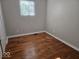 This bedroom boasts hardwood floors and a window for ample natural light at 706 Alexander St, Greenwood, IN 46143