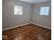 This bedroom boasts hardwood floors and two windows for ample natural light at 706 Alexander St, Greenwood, IN 46143