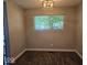 Inviting dining room with stylish flooring and a window for natural light; ideal for Gathering dinners at 706 Alexander St, Greenwood, IN 46143