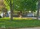 Charming home with well-maintained lawn, mature trees, and sun room at 706 Alexander St, Greenwood, IN 46143