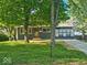 Charming single-story home with a well-maintained lawn and mature trees, offering great curb appeal at 706 Alexander St, Greenwood, IN 46143