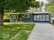 Charming single-story home featuring a well-manicured lawn and enclosed sunroom at 706 Alexander St, Greenwood, IN 46143