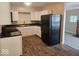 Bright kitchen featuring white cabinets, dark countertops, stainless steel sink, and modern flooring at 706 Alexander St, Greenwood, IN 46143