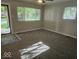 Bright living room with large windows, new carpet, and fresh paint; ready for your personal touch at 706 Alexander St, Greenwood, IN 46143