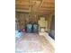 View of the wooden shed with trash bins, extra wood, and rolled carpet at 706 Alexander St, Greenwood, IN 46143