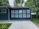 Enclosed sunroom providing ample natural light and a view of the backyard at 706 Alexander St, Greenwood, IN 46143