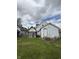 Backyard view of home featuring light siding and a small shed at 715 S Anderson St, Elwood, IN 46036