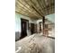 Bedroom with exposed ceiling, plaster walls and hardwood floors, shows the restoration potential at 715 S Anderson St, Elwood, IN 46036