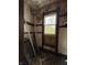 Damaged bedroom needing repair with broken window and peeling wallpaper at 715 S Anderson St, Elwood, IN 46036