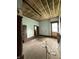 Bedroom with exposed ceiling and original wood floors ready for a modern transformation at 715 S Anderson St, Elwood, IN 46036
