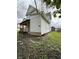 Exterior view of the side of the home, with a covered porch in view at 715 S Anderson St, Elwood, IN 46036