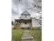 Two-story home featuring a covered front porch and light colored siding at 715 S Anderson St, Elwood, IN 46036