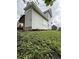 Exterior view of the side of the home, with a covered porch in view at 715 S Anderson St, Elwood, IN 46036