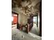 A hallway with old wallpaper and wood trim awaits renovation at 715 S Anderson St, Elwood, IN 46036
