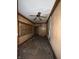 A living room reveals rustic wood paneling, original ceiling fan, and a window for natural light at 715 S Anderson St, Elwood, IN 46036