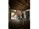 Spacious living room features exposed ceilings, brick fireplace, and original wood staircase, awaiting restoration at 715 S Anderson St, Elwood, IN 46036
