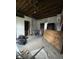 Living room with exposed ceiling reveals space ready for remodel at 715 S Anderson St, Elwood, IN 46036
