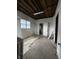 A room with exposed framework awaits renovation at 715 S Anderson St, Elwood, IN 46036