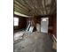 A room with exposed framework awaits renovation at 715 S Anderson St, Elwood, IN 46036