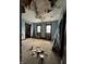A room with peeling paint and exposed framework awaits renovation at 715 S Anderson St, Elwood, IN 46036