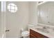 Powder room with white walls, wood cabinet with light countertop and wood-look flooring at 7156 Chemistry Ct, Indianapolis, IN 46239