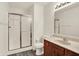 Well-lit bathroom with a framed shower and a vanity with warm wood cabinets at 7156 Chemistry Ct, Indianapolis, IN 46239