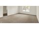 Bright, carpeted bedroom featuring a door opening into an adjacent bathroom at 7156 Chemistry Ct, Indianapolis, IN 46239