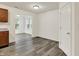 Dining room with gray wood-look floors, white walls, and a view into the living room at 7156 Chemistry Ct, Indianapolis, IN 46239