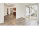 Bright dining area with gray tile floors, sliding glass door, and view to the kitchen at 7156 Chemistry Ct, Indianapolis, IN 46239