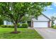 A well-maintained single-Gathering home showcasing a two-car garage and tidy front yard landscaping at 7156 Chemistry Ct, Indianapolis, IN 46239