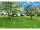 Inviting front yard with mature trees and manicured lawn, enhancing the home's appeal and providing a serene setting at 7156 Chemistry Ct, Indianapolis, IN 46239