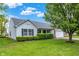 Charming single-story home boasts a manicured lawn and lush landscaping, enhancing its curb appeal at 7156 Chemistry Ct, Indianapolis, IN 46239