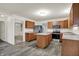 Bright kitchen featuring wood cabinets, stainless steel appliances, center island and gray wood-look floors at 7156 Chemistry Ct, Indianapolis, IN 46239