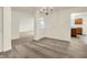 Expansive living space with plush carpeting and neutral walls, illuminated by a decorative chandelier at 7156 Chemistry Ct, Indianapolis, IN 46239