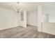 An open, carpeted living area featuring a classic chandelier and pristine white walls for a bright feel at 7156 Chemistry Ct, Indianapolis, IN 46239