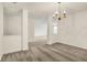 Neutral living room featuring soft gray carpets, white walls and a view to the kitchen at 7156 Chemistry Ct, Indianapolis, IN 46239