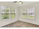 Bright room with neutral tile floors and three windows with a green view at 7156 Chemistry Ct, Indianapolis, IN 46239