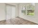 Bright room with tile floors, sliding glass door, and two windows with a green view at 7156 Chemistry Ct, Indianapolis, IN 46239