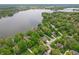 A vast aerial view showcasing a lake community with a variety of homes, lush trees, and waterfront properties at 7400 Oakbay Dr, Noblesville, IN 46062
