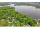 Wide aerial shot showcasing the community, a waterfront property, mature trees, and verdant green lawns at 7400 Oakbay Dr, Noblesville, IN 46062