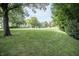 Expansive green lawn is perfect for outdoor activities and features a wooded backdrop for enhanced privacy at 7400 Oakbay Dr, Noblesville, IN 46062