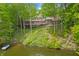 A home situated on a waterfront lot featuring a large deck, screened in porch, and verdant backyard at 7400 Oakbay Dr, Noblesville, IN 46062