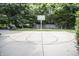 Full-sized basketball court surrounded by lush trees for a private recreational area and playing games at 7400 Oakbay Dr, Noblesville, IN 46062