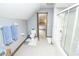 Charming bathroom with a shower and tub combination and calming blue wallpaper at 7400 Oakbay Dr, Noblesville, IN 46062