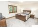 A cozy main bedroom is bathed in natural light with neutral carpet and trim plus classic sleigh bed at 7400 Oakbay Dr, Noblesville, IN 46062