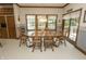 Cozy dining area with a large wooden table and views of the lush exterior at 7400 Oakbay Dr, Noblesville, IN 46062