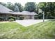Large home exterior featuring a private basketball court, double car garage, and well-manicured lawn at 7400 Oakbay Dr, Noblesville, IN 46062