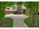 Stately brick home featuring a circle driveway, manicured landscaping, and an attached three-car garage at 7400 Oakbay Dr, Noblesville, IN 46062