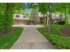 Stately brick home featuring a circle driveway, manicured landscaping, and an attached three-car garage at 7400 Oakbay Dr, Noblesville, IN 46062