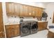 Laundry room with washer, dryer, sink, and cabinets at 7400 Oakbay Dr, Noblesville, IN 46062
